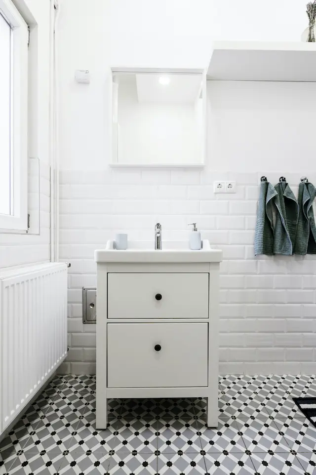 A single sink white bathroom vanity.