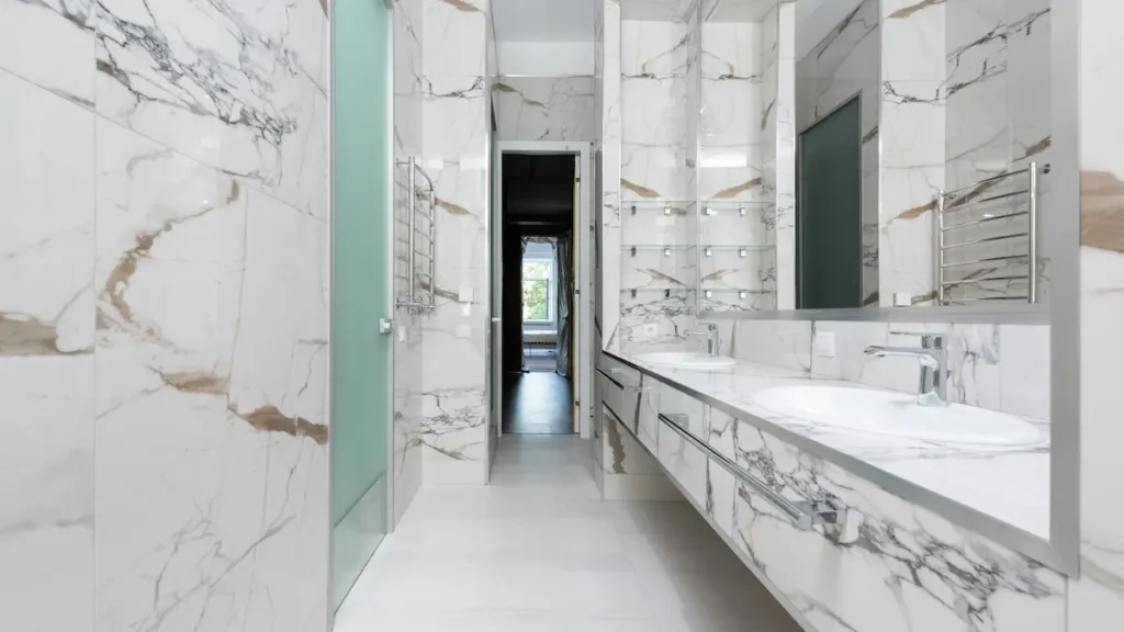 A wide marble bathroom vanity.